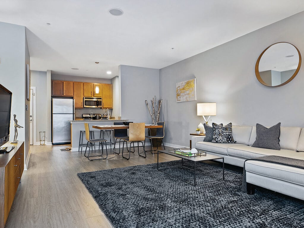 A spacious living room and kitchen at the Axis Admiral’s Hill Apartments in Chelsea, Massachusetts.